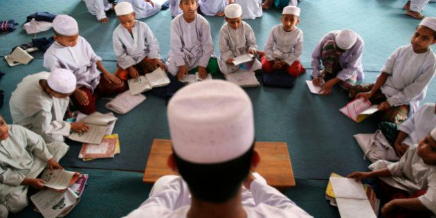 A madrasa, or Muslim religious school teacher teaches his students in Dhaka, Bangladesh, Sunday, April 19, 2009. Bangladesh's Prime Minister Sheikh Hasina sought the cooperation of Islamic leaders and scholars Saturday to fight against terrorism. (AP Photo/Pavel Rahman)