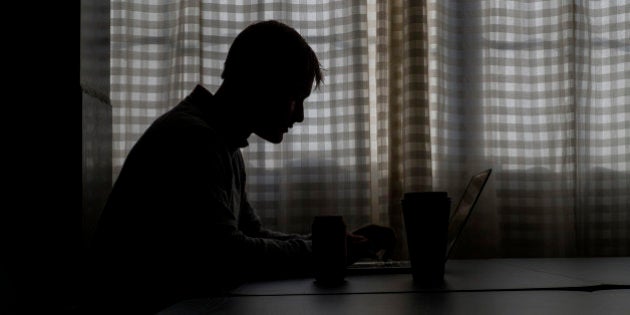 The silhouette of Ryan Hoover, founder and chief executive officer at Product Hunt, is see as he works on a computer at the company's office in San Francisco, California, U.S., on Wednesday, Feb. 4, 2015. Hoover, who at 28 bears a passing resemblance to a pre-bad boy Justin Bieber, is one of the most visible benefactors of the easy money fueling the tech boom, an earnest, hustling, unconventional power broker in San Francisco's let's-create-a-company culture. Photographer: David Paul Morris/Bloomberg via Getty Images