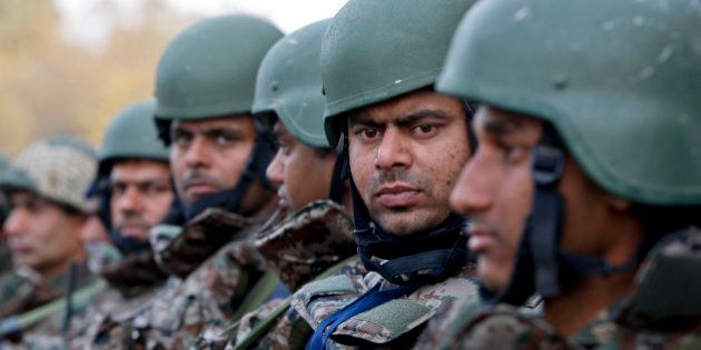 Indian army soldiers stand at the Indian air force base in Pathankot, India, Tuesday, Jan.5, 2016. Indian forces have killed the last of the six militants who attacked the air force base near the Pakistan border over the weekend, the defense minister said Tuesday, though soldiers were still searching the base as a precaution. (AP Photo/Channi Anand)