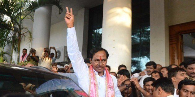 Indian Telangana Rashtra Samithi (TRS) party president K Chandrasekhar Rao (C) greets supporters at Telangana Bhavan in Hyderabad on May 16, 2014. Telangana Rashtra Samithi led by K Chandrasekhar Rao is set to form the first government in Telangana state with his party heading towards a majority in the Assembly polls. India's triumphant Hindu nationalists declared 'the start of a new era' in the world's biggest democracy after hardline BJP leader Narendra Modi propelled them to a stunning win on a platform of revitalizing the sickly economy .AFP PHOTO / Noah SEELAM (Photo credit should read NOAH SEELAM/AFP/Getty Images)