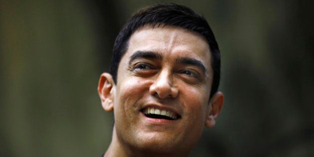 Bollywood actor Aamir Khan smiles as he takes questions from a journalist during a press conference to promote his new film