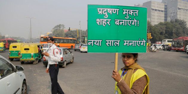 A volunteer holds a placard which reads