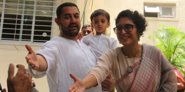 MUMBAI, INDIA - JULY 18: Bollywood actor Aamir Khan with wife Kiran Rao and son Azaad greets fans at Carter Road residence on the occasion of EID on July 18, 2015 in Mumbai, India. (Photo by Pramod Thakur/Hindustan Times via Getty Images)