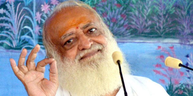 This photograph taken on August 11, 2013, shows self-styled Indian 'godman' Asaram Bapu as he gestures during a ceremony in Jodhpur. The popular Indian guru remained defiant over allegations that he sexually assaulted a schoolgirl, angrily saying he was 'ready to go to prison' over the affair. AFP PHOTO/STR (Photo credit should read STRDEL/AFP/Getty Images)