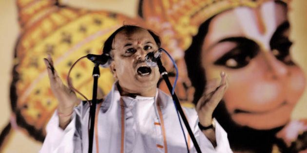 BANGALORE, INDIA: Vishwa Hindu Parishad (VHP,World Hindu Council) international secretary Pravin Togadia gestures whilst standing in front of a billboard with a painting depicting the Hindu Monkey God Hanuman as he addresses a rally in Bangalore, 07 December 2003 . Togadia urged those attending the rally to support the cause for the reconstruction of the Ram Temple in Ayodhya. In 1992 Hindu fundamentalists razed a 16th century mosque to the ground in the Northern Indian town, which they claimed was built on the site of the birthplace of the Hindu God Ram. AFP PHOTO/Indranil MUKHERJEE (Photo credit should read INDRANIL MUKHERJEE/AFP/Getty Images)