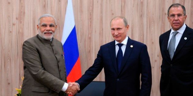 In this photo taken Tuesday, July 15, 2014, Russian President Vladimir Putin, centre, and Indian Prime Minister Narendra Modi, left, shake hands during their meeting attended, by Russian Foreign Minister Sergey Lavrov, right, at the sidelines of the BRICS 2014 summit in Fortaleza, Brazil. The leaders of the BRICS nations are meeting in Brazil for a summit where they are expected to officially create a bailout and development fund worth $100 billion. (AP Photo/RIA-Novosti, Mikhail Klimentyev, Presidential Press Service)