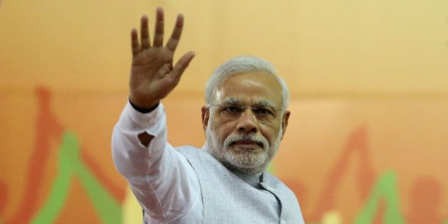 India's Prime Minister Narendra Modi waves to his supporters after addressing a rally organized by his party, the ruling Bharatiya Janata Party (BJP), in Bangalore, India, Friday, April 3, 2015. Modi's speech was mostly addressed to farmers on a day that President Pranab Mukherjee signed off on the latest version of the government's land acquisition ordinance, which proposes to ease rules for acquiring land to facilitate infrastructure projects, in a country where agriculture is the main livelihood of about 60 percent of the 1.2 billion people. (AP Photo/Aijaz Rahi)