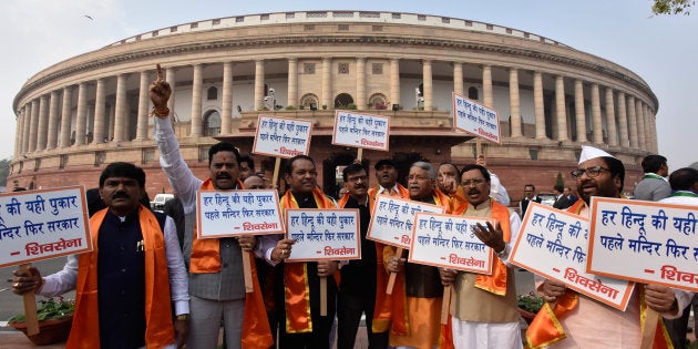 Shiv Sena MPs display placards while staging a protest during the Parliament Winter Session.