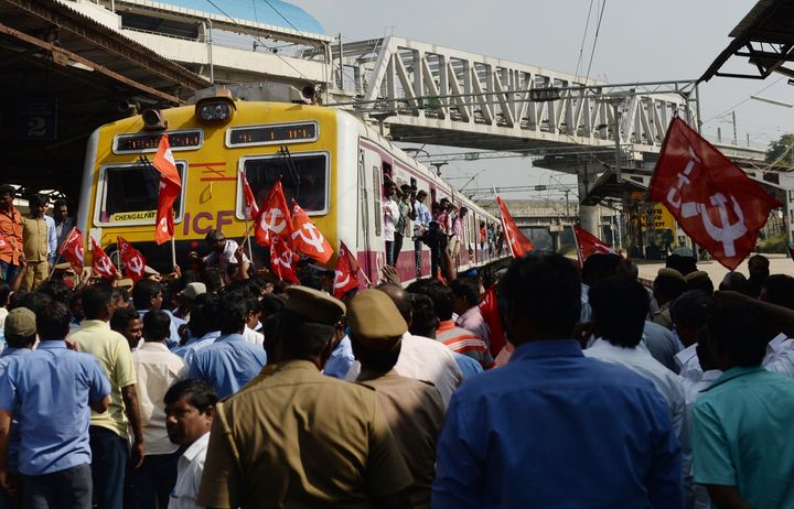 Members of the Centre of Indian Trade Unions (CITU) stop a train in Chennai during the nationwide strike.
