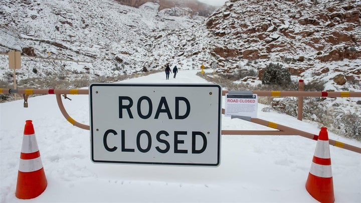 Visitors walk up the road in Arches National Park in Utah during the partial government shutdown. Some states have had to foot the bill to keep bathrooms clean and parks staffed. 