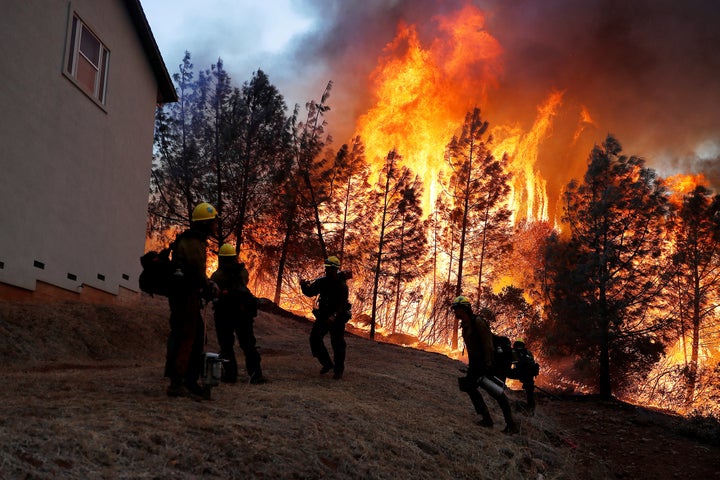 A group of U.S. Forest Service firefighters monitor a back fire while battling to save homes at the Camp Fire in Paradise, California, U.S. November 8, 2018. 