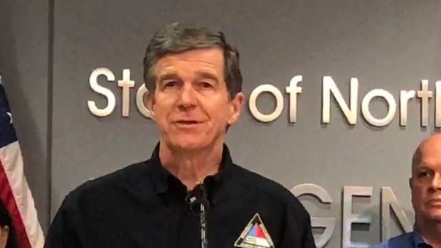 In this Sept. 12, 2018 photo, North Carolina Gov. Roy Cooper, left, speaks at a news conference about Hurricane Florence preparedness as attended by state Transportation Secretary Jim Trogdon, right, listens in Raleigh, N.C. Cooper has been praised by many, including Republicans, for his handling of the state’s immediate response to Florence (AP Photo/Gary D. Robertson)