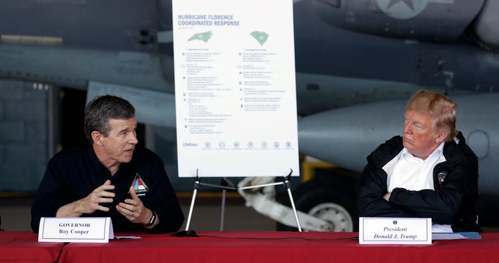 President Donald Trump listens to North Carolina Gov. Roy Cooper, left, during a presidential visit Sept. 19 to areas impacted by Hurricane Florence.