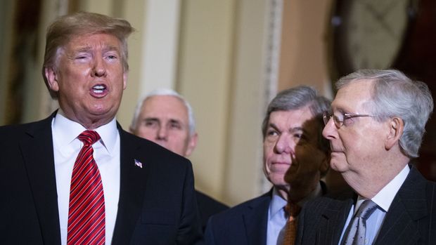 U.S. President Donald Trump, left, speaks to members of the media following a Senate Republicans policy luncheon at the U.S. Capitol in Washington, D.C., U.S., on Wednesday, Jan. 9, 2019. Republican members of Congress are 'very, very unified' behind continuing the partial government shutdown, Trump said after meeting with GOP senators. Photographer: Al Drago/Bloomberg via Getty Images