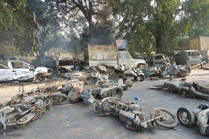 Smouldering vehicles are seen following mob violence in Bulandhahr.