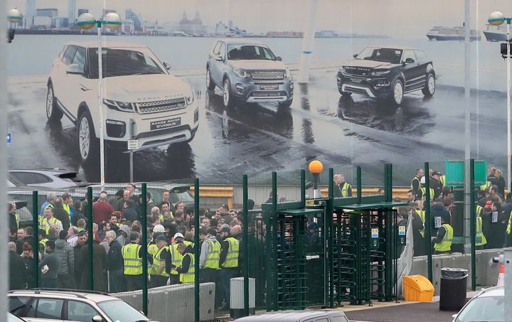 Staff gather outside the Jaguar Land Rover site in Halewood, Knowsley, Merseyside. The luxury carmaker is giving a business update on Thursday which is reported to announce thousands of job losses.