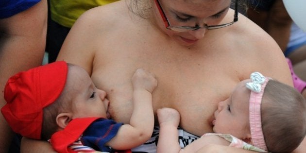 A woman breastfeeds her babies during a demo against discrimination on October 4, 2014 in Asuncion. AFP PHOTO / Norberto Duarte (Photo credit should read NORBERTO DUARTE/AFP/Getty Images)