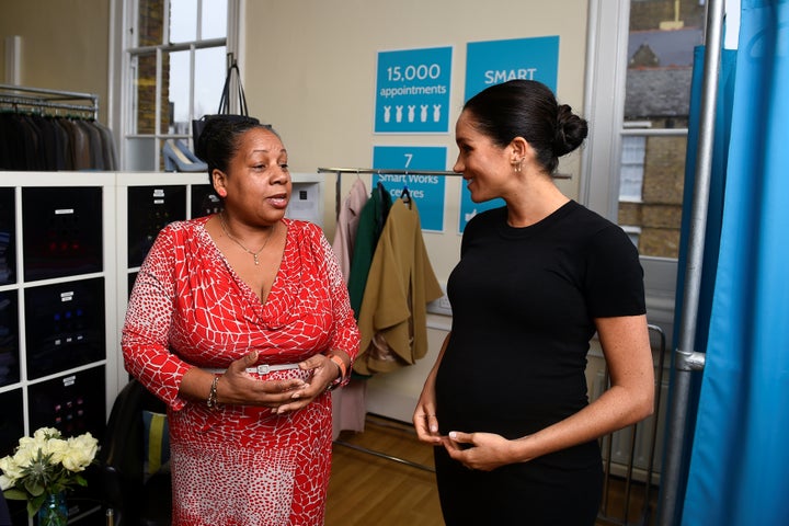 The Duchess of Sussex chats with Patsy Wardally as they pick out clothes. 