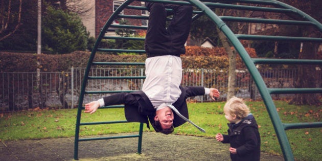 Father and son having fun playing in the park together