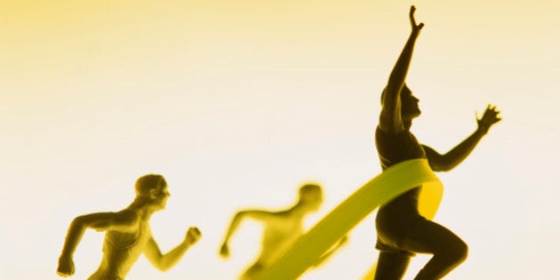 Figurines of men running reaching finish line