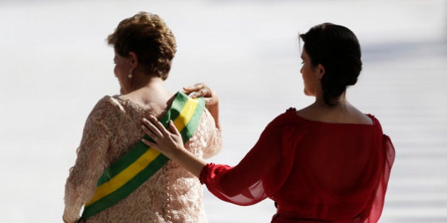 Paula places her hand on the back of her mother, Brazil's President Dilma Rousseff, after Rousseff received the presidential sash after being sworn in for a second four-year term in Brasilia January 1, 2015. Brazil's President Dilma Rousseff began her second term Thursday vowing to rein in government spending to curb inflation and pull Latin America's largest economy out of a four-year slump. REUTERS/Ueslei Marcelino (BRAZIL - Tags: POLITICS)