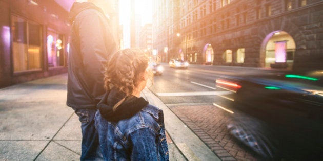 father and daughter about to cross street