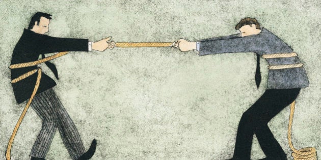 Two businessmen having a tug of war