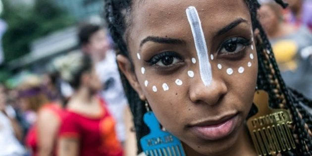 SAO PAULO, BRAZIL MARCH 8: Woman with make up gestures during the International Women's Day celebration in Sao Paulo, Brazil on March 8, 2016. Hundreds of women protest violence against women and chant slogans in favor of abortion during the event. (Photo by Dário Oliveira/Anadolu Agency/Getty Images)