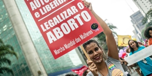 SAO PAULO, BRAZIL MARCH 8: Girl holds a poster for legalizing abortion during the International Women's Day celebration in Sao Paulo, Brazil on March 8 , 2016. Hundreds of women protest violence against women and chant slogans in favor of abortion during the event. (Photo by Dário Oliveira/Anadolu Agency/Getty Images)