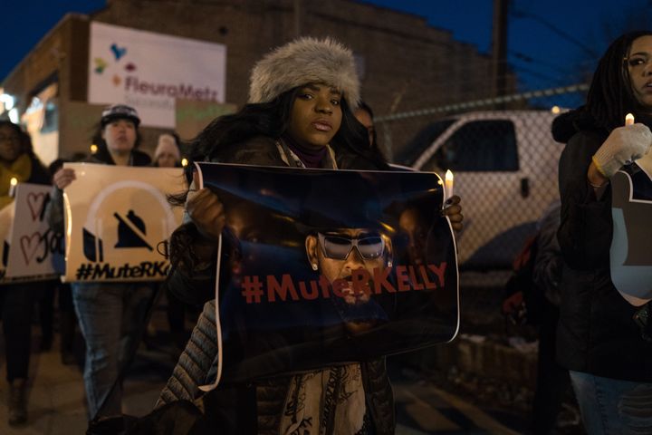 An activist holds a "Mute R. Kelly" sign in Chicago. 