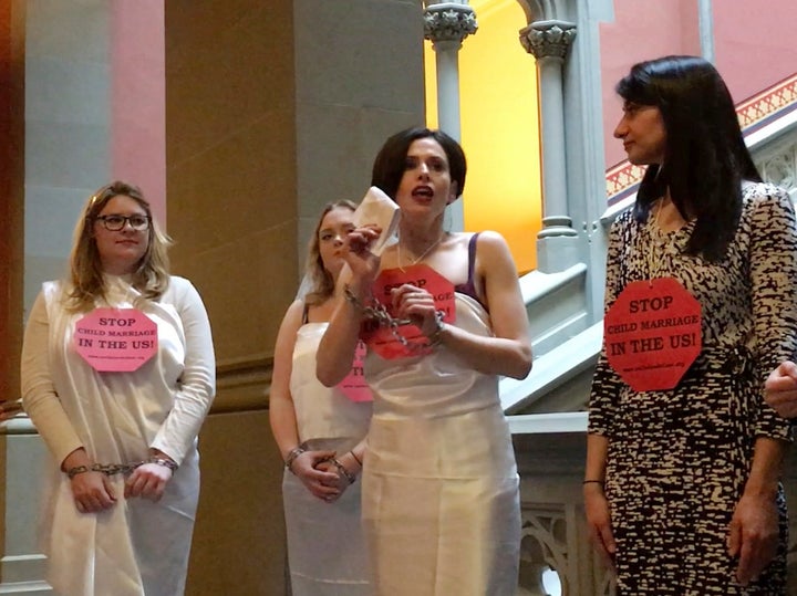 In this image taken from video, Fraidy Reiss, center, founder and executive director of Unchained at Last, demonstrates in chains at the State Capitol in Albany, N.Y., on Feb. 14, 2017. 