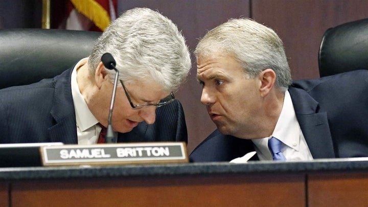 Mississippi Public Service commissioner for the Northern District, Brandon Presley, right, confers with Southern District commissioner Sam Britton. The state’s Public Service commissioners, electric cooperatives and several local and state groups want to see a 77-year-old state law changed to allow electric cooperatives to provide internet services. 