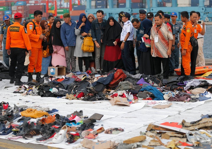 In this Oct. 31, 2018 file photo, relatives of passengers check personal belongings retrieved from the waters where the airpl