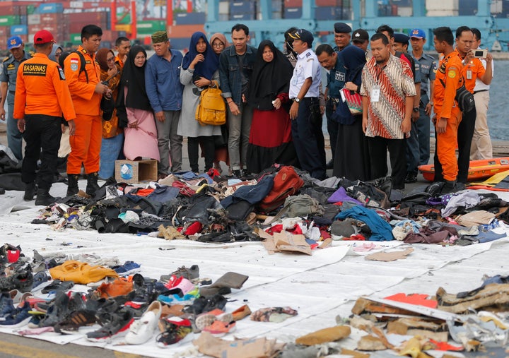 In this Oct. 31, 2018 file photo, relatives of passengers check personal belongings retrieved from the waters where the airplane is believed to have crashed.