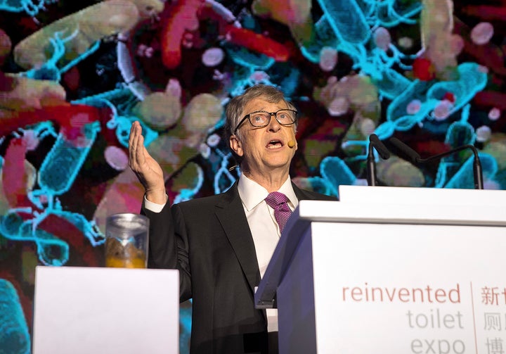 Bill Gates stands next to a jar of feces as he addresses delegates at the Reinvented Toilet Expo in China in November 2018.