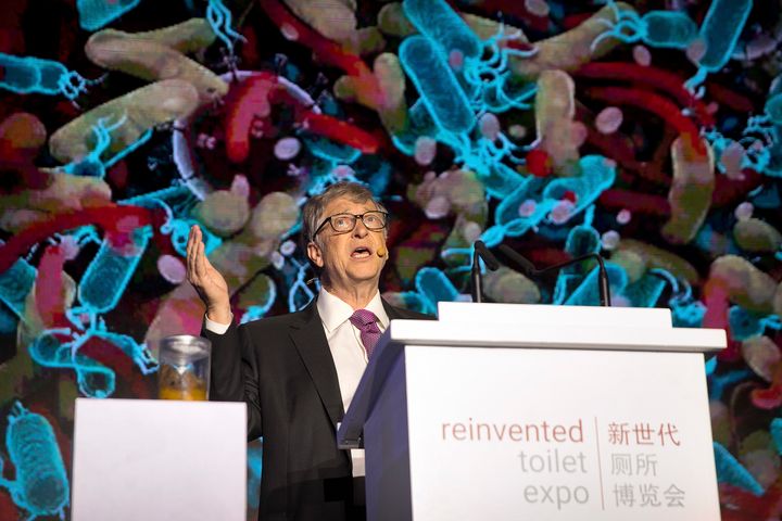 Bill Gates stands next to a jar of feces as he addresses delegates at the Reinvented Toilet Expo in China in November 2018.