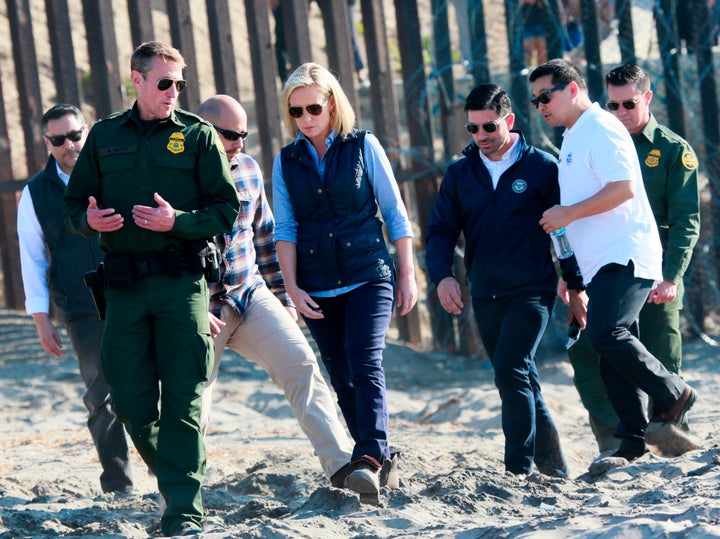 Homeland Security Secretary Kirstjen Nielsen tours the border area with San Diego Section Border Patrol Chief Rodney Scott, left, in San Ysidro, California, on Nov. 20.