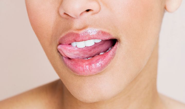 Although it may seem a good idea at the time, “as the saliva dries and evaporates, it draws moisture away from the skin."