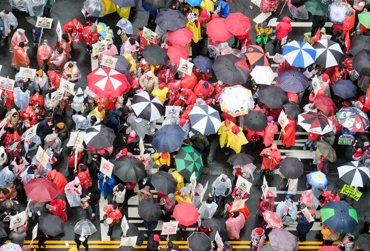 Teachers and supporters hold signs in the rain during a rally on Jan. 14, 2019, in Los Angeles.