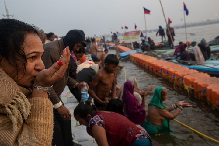 A pilgrim prays at Sangam, the confluence of the rivers Ganges, Yamuna and mythical Saraswati, during the Kumbh Mela festival in Allahabad, India, Monday, January 14, 2019.