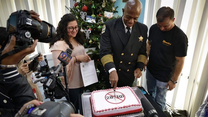 Sheriff Garry McFadden of Mecklenburg County, North Carolina, celebrates his election in November by slicing a cake frosted w