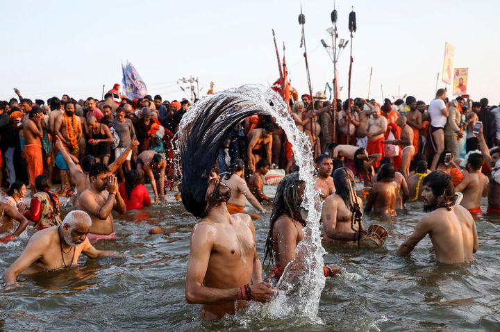 Naga Sadhus or Hindu holy men take a dip during the first bath at Kumbh Mela in Prayagraj, January 15, 2019. 