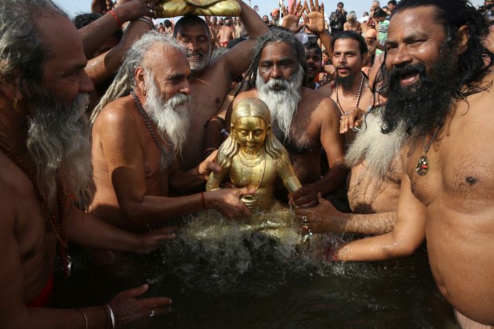 Saints of the Shri Panchayati Naya Udasin Akhada give a ritualistic bath to patron deity Jagatguru Srichandra Bhagwan at the confluence of rivers Ganga, Yamuna and the mythical river Saraswati in Prayagraj, Uttar Pradesh state, India, Tuesday, Jan. 15, 2019.