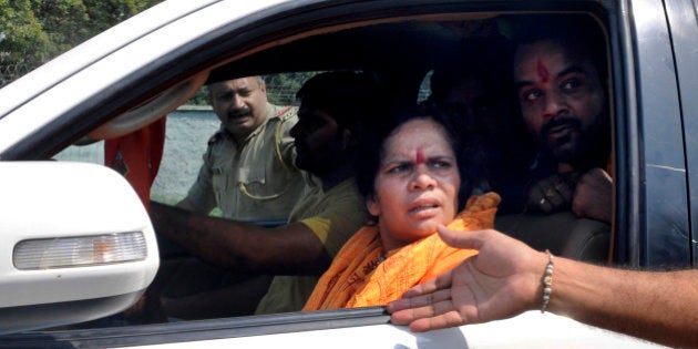 DADRI, INDIA - OCTOBER 7: BJP leader Sadhvi Prachi convoy stopped from entering Bisada on October 7, 2015 in Dadri, India. Last week a 50-year-old man, Mohammad Akhlaq (Ikhlaq), was lynched for allegedly buying and eating beef in his house in Bishada village. (Photo by Sunil Ghosh/Hindustan Times via Getty Images)