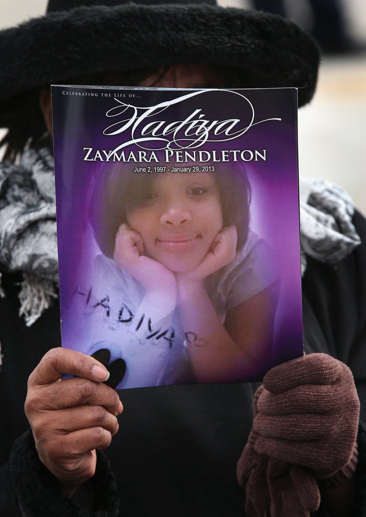 Minister Elnor Brown holds up a funeral program outside the Greater Harvest M.B. Church during the funeral of 15-year-old Hadiya Pendleton on Fe. 9, 2013, in Chicago, Illinois.