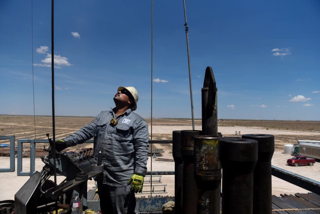 A contractor works on a drilling site in the Permian Basin, a massive field stretching from Texas to...