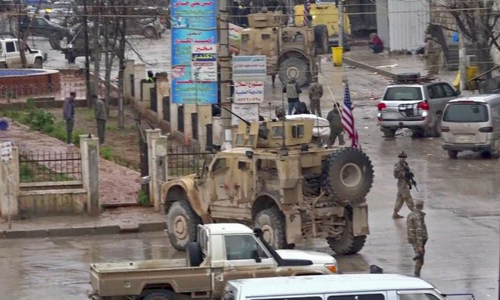 An image grab taken from a video obtained by AFPTV on January 16, 2019, shows U.S. troops gathered at the scene of a suicide attack in the northern Syrian town of Manbij. (-/AFP/Getty Images)