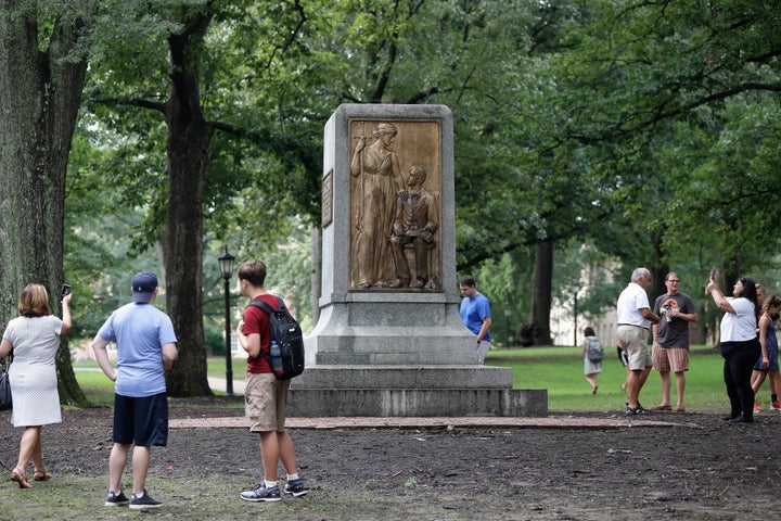 People gather around the remainder of the Silent Sam monument after it was toppled from its pedestal by protesters at the University of North Carolina in Chapel Hill in August. Early Tuesday morning, the remainder of the monument was taken down.