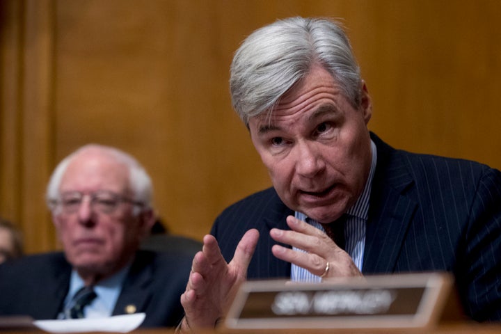 Sen. Sheldon Whitehouse (D-R.I.), right, accompanied by Sen. Bernie Sanders, (I-Vt.), left, questioned Wheeler at the hearing. 