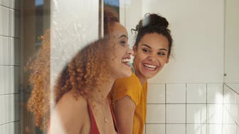 Young women having a good time and hanging out, at youth hostel with bunk beds